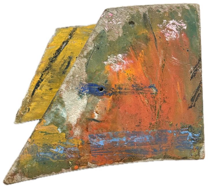 a broken board in orange, olive and blue, yellow at one edge