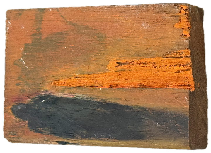 a block of wood with an orange band over grey-blue
