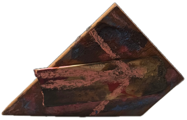 a triangular block of wood worked in pink, red and blue, standing on its edge