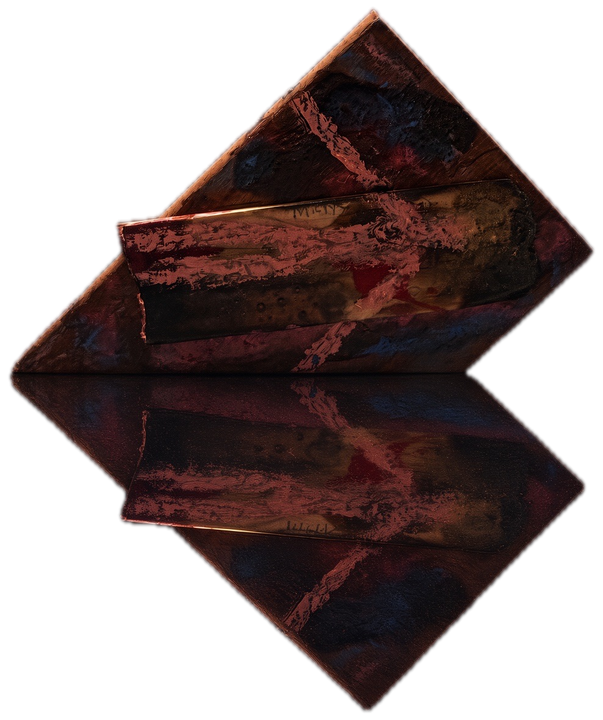a carved relief of arrows on a dark red-brown ground